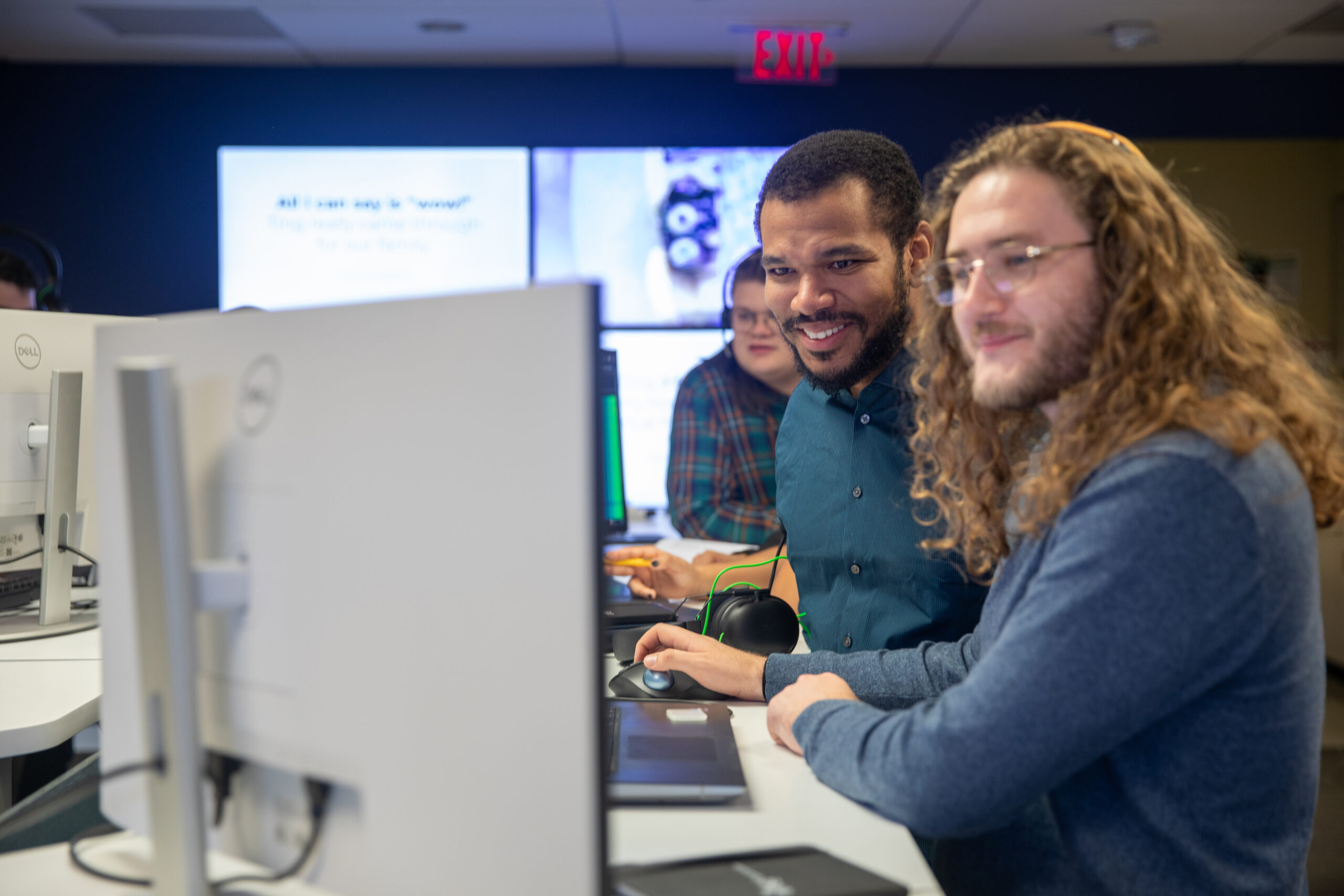 Three engineers working at a computer station
